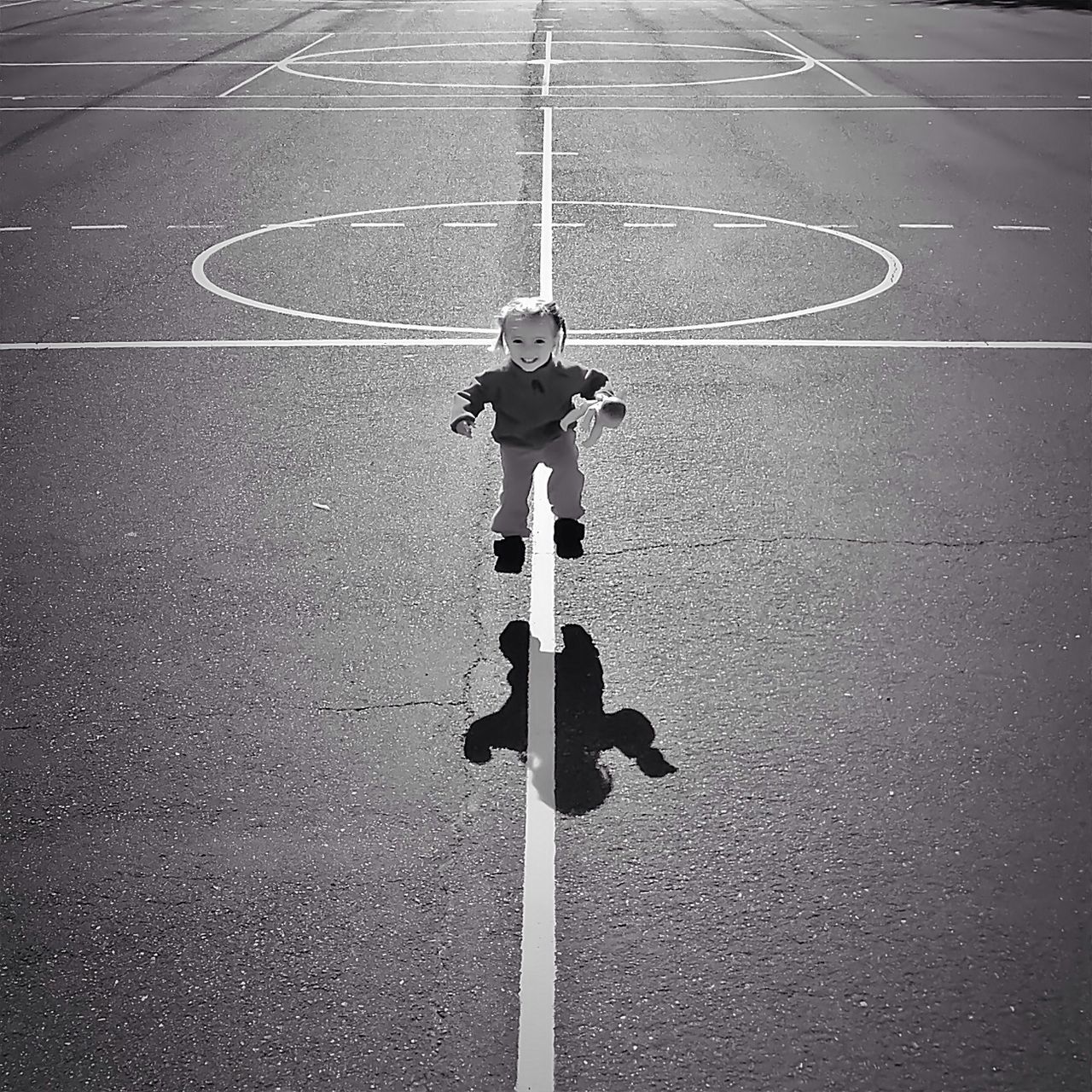 street, road, road marking, transportation, asphalt, high angle view, shadow, the way forward, day, full length, men, leisure activity, outdoors, lifestyles, sunlight, road sign, pole, guidance