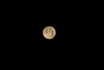 Low angle view of full moon against sky at night