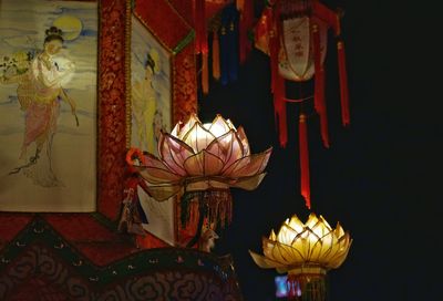 Low angle view of illuminated lantern hanging on ceiling