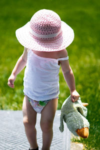 Toddler girl holding stuffed toy