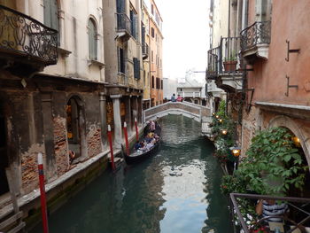 Bridge over canal amidst buildings in city