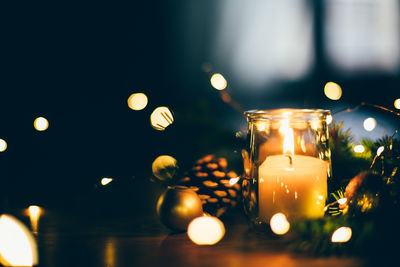 Close-up of illuminated candles on table