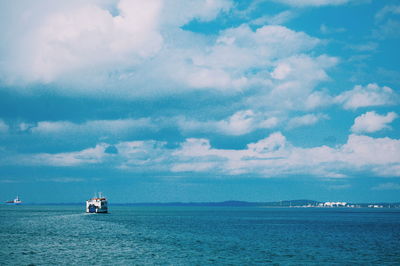 Sailboat sailing on sea against sky