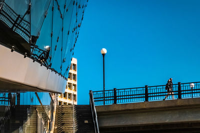 Low angle view of bridge against clear blue sky