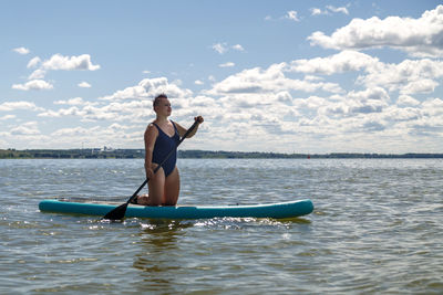 Full length of woman swimming in sea against sky