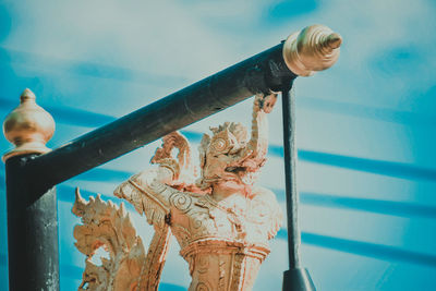 Close-up of female statue by swimming pool