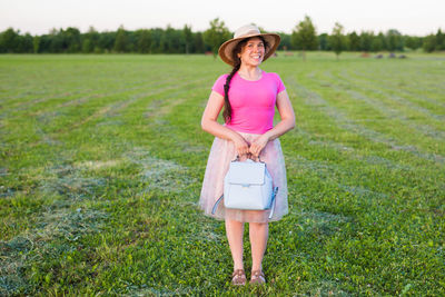 Portrait of woman standing on field