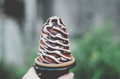 Close-up of hand holding ice cream cone