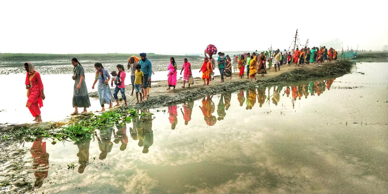 PEOPLE WALKING ON BEACH