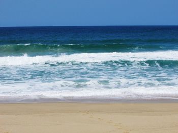 Scenic view of sea against clear blue sky