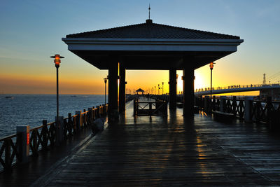 Pier on sea during sunset
