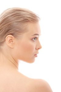 Close-up portrait of a serious young woman over white background