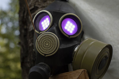Gas mask with flame in eyes. purple light from eye sockets. smoke protection. 