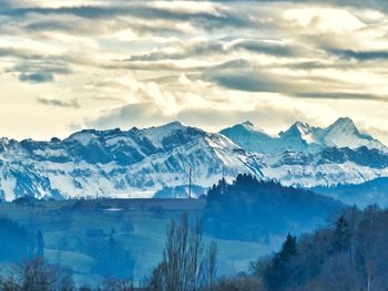 Scenic view of snowcapped mountains against sky