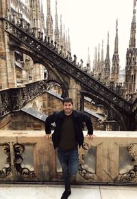 Portrait of smiling young man standing at duomo di milano