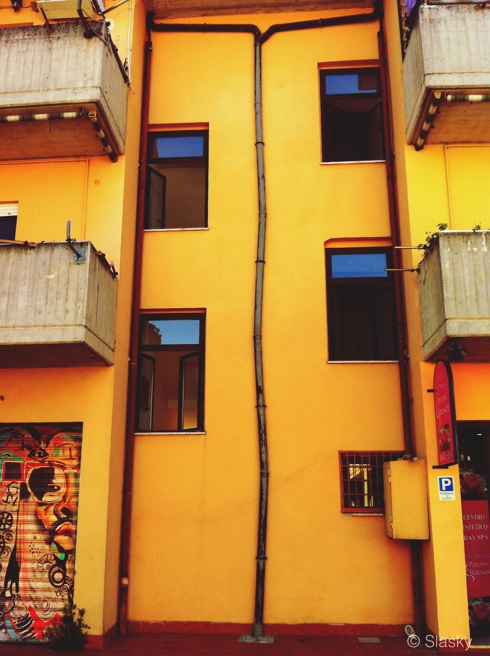 architecture, building exterior, built structure, window, yellow, residential building, low angle view, residential structure, building, house, balcony, orange color, full frame, no people, outdoors, day, facade, city, door, backgrounds