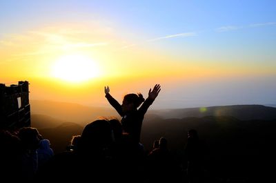 Silhouette of people at sunset