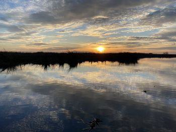 Scenic view of lake against sky during sunset