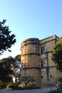 Low angle view of old building against clear blue sky