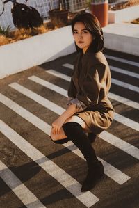 Portrait of woman crossing road