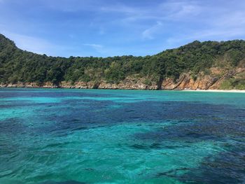 Scenic view of sea against blue sky