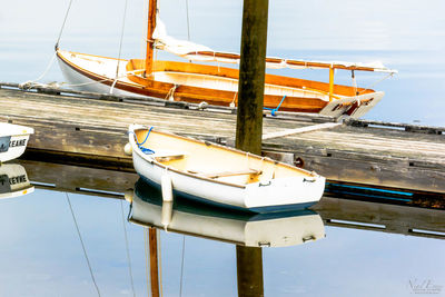 Low angle view of sailboats moored on sea against sky