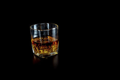 Close-up of wine glass against black background