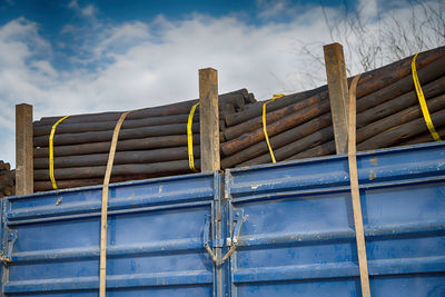 Low angle view of metallic structure against blue sky