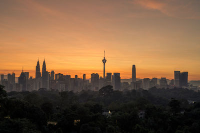 Buildings in city at sunset