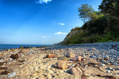 Rocks on beach against sky