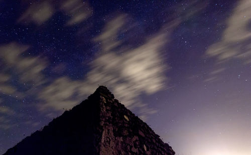 Low angle view of mountain against sky at night