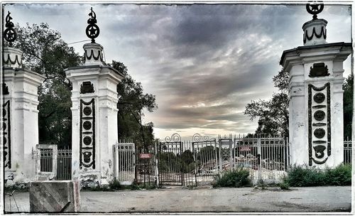 Gate against cloudy sky