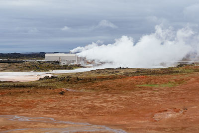 Smoke emitting from industry against sky