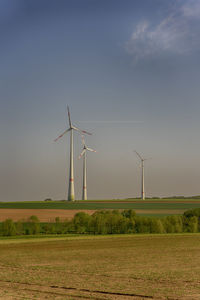 Windmill on field against sky