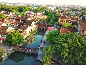 High angle view of townscape by river in city