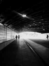 Rear view of silhouette people walking in subway