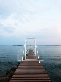 Pier on sea against sky