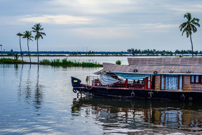 Boat moored in sea against sky