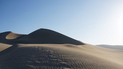 Scenic view of desert against clear sky