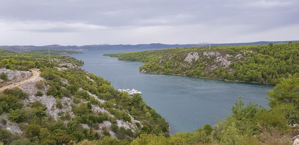 Scenic view of sea and trees against sky