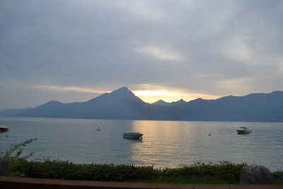 Scenic view of sea and mountains against sky