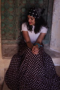 Midsection of woman standing against wall