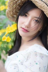 Portrait of beautiful young woman wearing hat