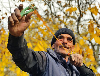 Portrait of man holding mobile phone