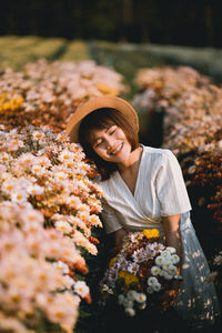 Portrait of young woman with flower bouquet