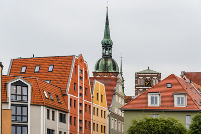 Traditional colorful houses and church tower in the old town of stralsund.