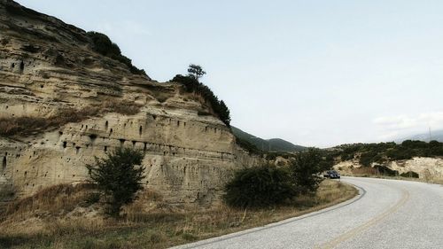 Scenic view of mountain road against clear sky