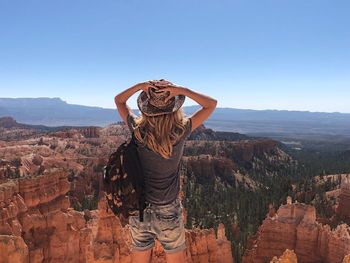 Rear view of woman looking at rock formations at bryce canyon