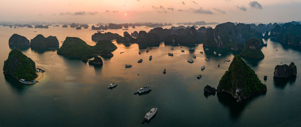 High angle view of rocks in sea during sunset