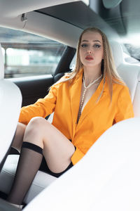 Young woman sitting in car